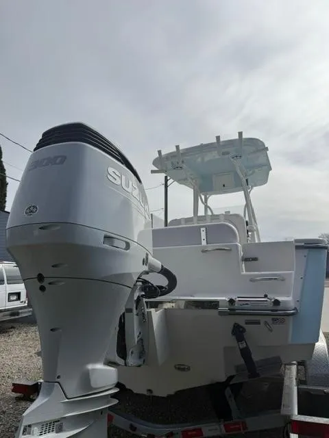 Slide: The Image of 2025 Sea Born LX24 Center Console boat with Suzuki outboard motor on trailer. - 24