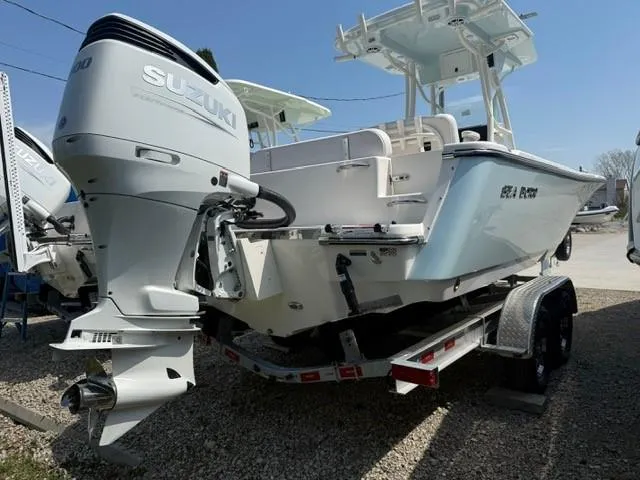 Slide: The Image of 2025 Sea Born LX24 Center Console boat with Suzuki outboard motor on trailer. - 25