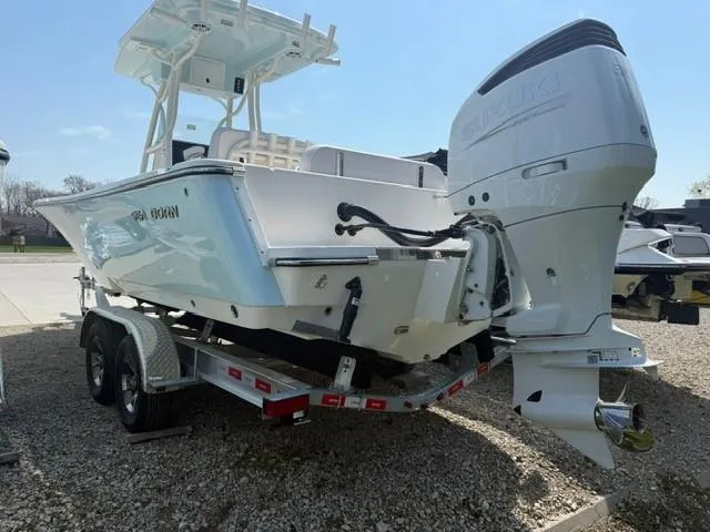 Slide: The Image of 2025 Sea Born LX24 Center Console boat on trailer, featuring powerful outboard motor. - 3