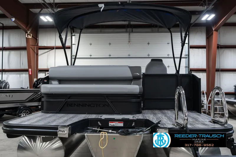 Slide: The Image of 2025 Bennington 21 SLJ pontoon boat in showroom, featuring sleek design and modern amenities. - 10
