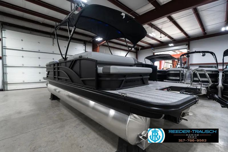 Slide: The Image of 2025 Bennington 21 SLJ pontoon boat in showroom, featuring sleek design and modern amenities. - 11