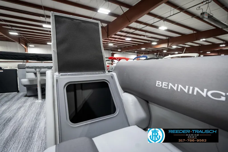 Slide: The Image of 2025 Bennington 21 SLJ boat interior with open storage compartment in showroom. - 25