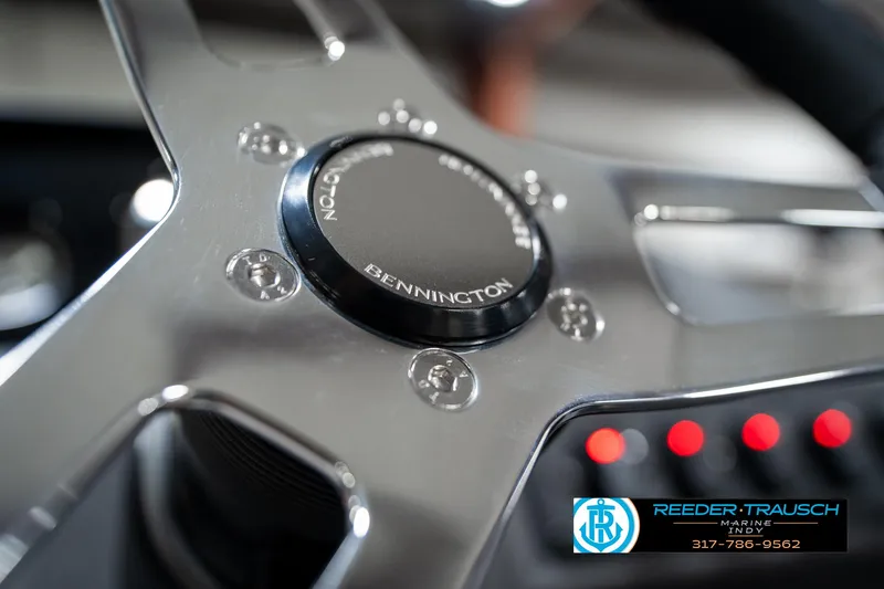 Slide: The Image of Steering wheel of 2025 Bennington 21 SLJ boat with logo and control panel. - 35