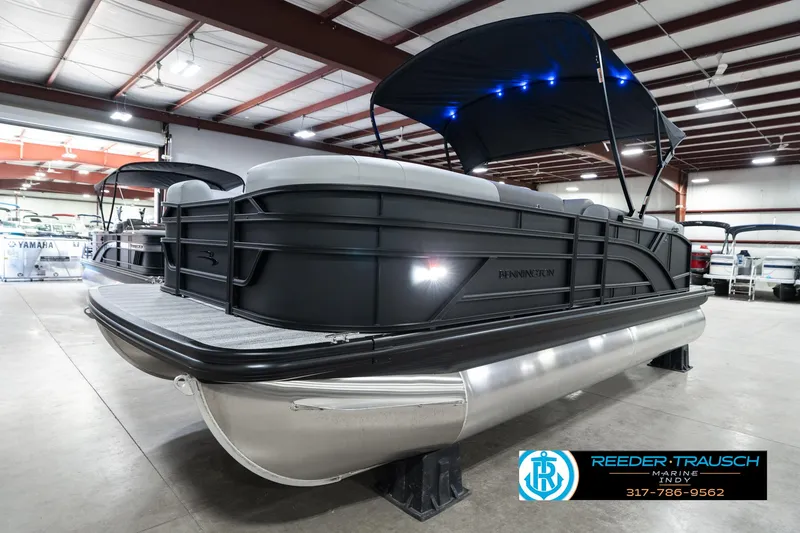 Slide: The Image of 2025 Bennington 21 SLJ pontoon boat in showroom with canopy and LED lights. - 4