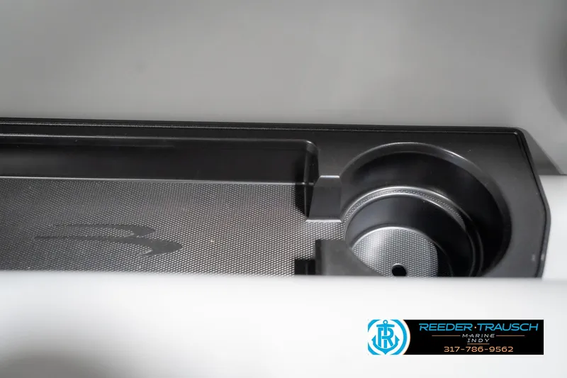 Slide: The Image of 2025 Bennington 21 SLJ boat interior detail with cup holder and storage tray. - 47