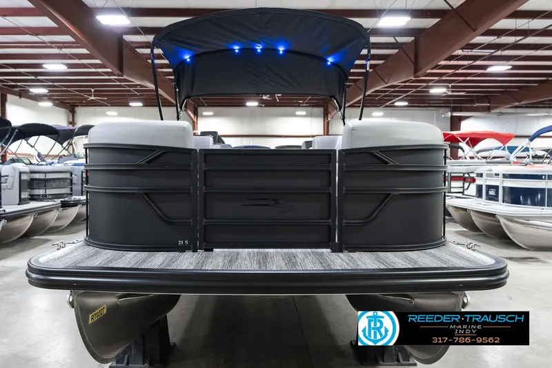 Slide: The Image of 2025 Bennington 21 SLJ pontoon boat in showroom with canopy and LED lights. - 6