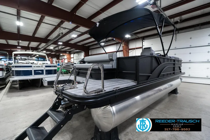 Slide: The Image of 2025 Bennington 21 SLJ pontoon boat in showroom, featuring sleek design and modern amenities. - 9