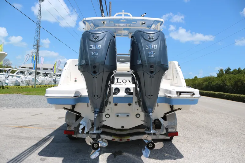 Slide: The Image of 2023 Robalo R317 boat with dual Yamaha 300 V6 outboard engines, rear view. - 11