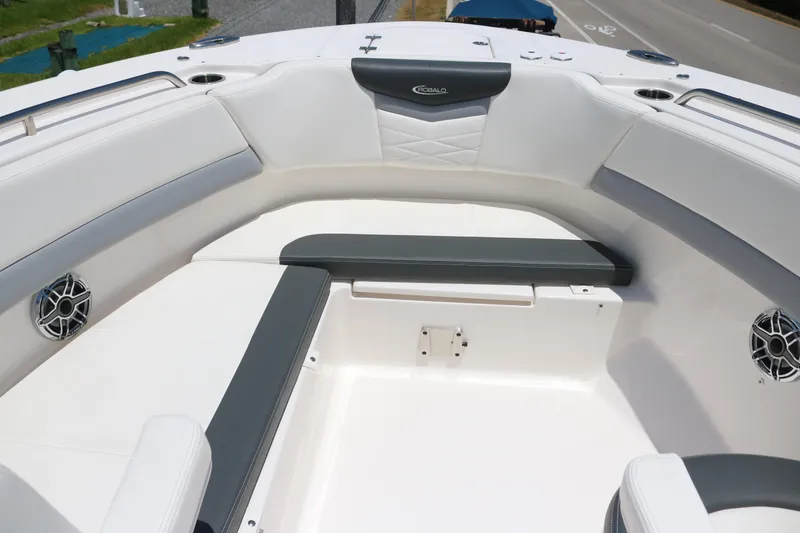 Slide: The Image of 2023 Robalo R317 boat interior with white and gray seating, cup holders, and speakers. - 13