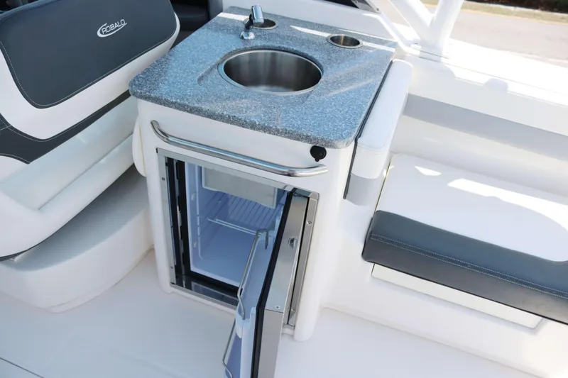 Slide: The Image of 2023 Robalo R317 boat interior with sink and mini fridge. - 20