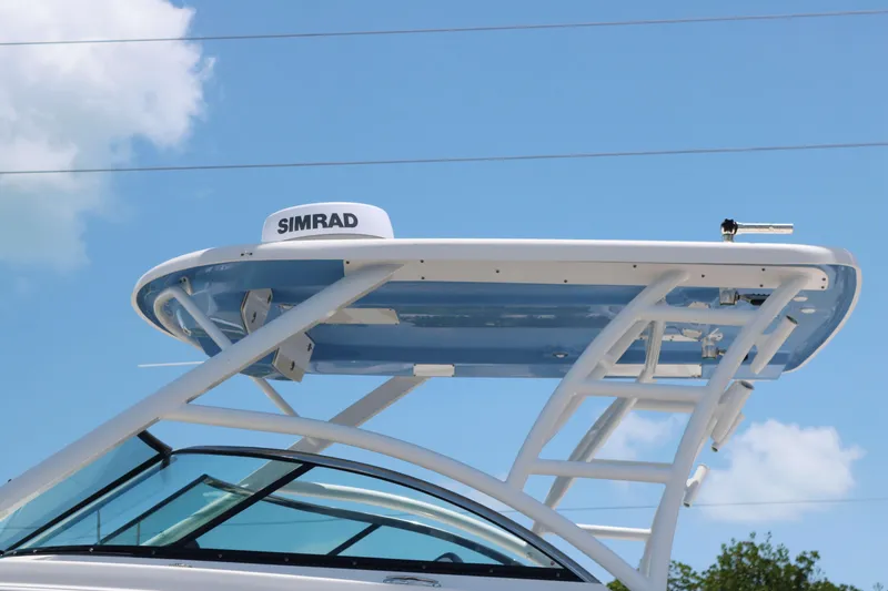 Slide: The Image of 2023 Robalo R317 boat with Simrad radar, blue sky background. - 5