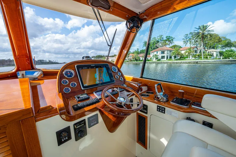 Slide: The Image of Helm of 2017 Hinckley Picnic Boat 37 MKIII with scenic waterfront view. - 12