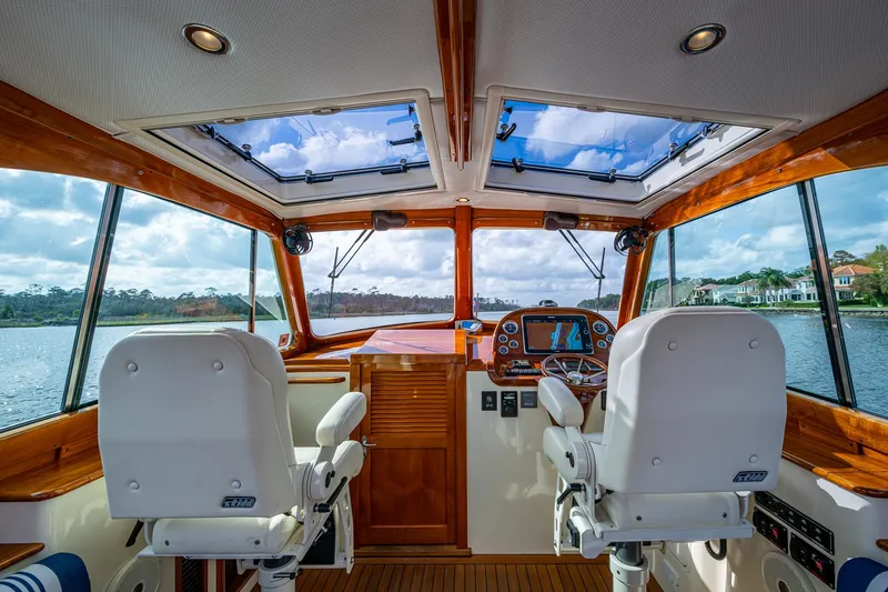 Slide: The Image of Interior view of 2017 Hinckley Picnic Boat 37 MKIII helm with dual seats and panoramic windows. - 13