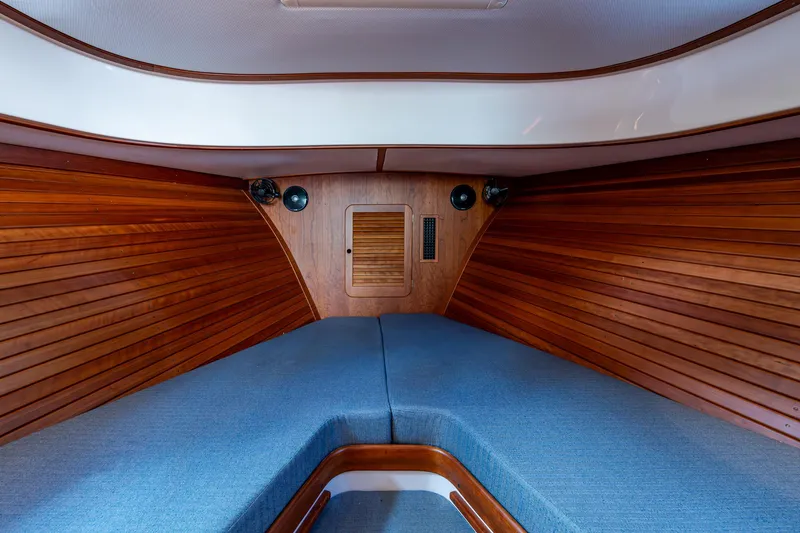 Slide: The Image of 2017 Hinckley Picnic Boat 37 MKIII cabin with wooden interior and blue upholstery. - 21