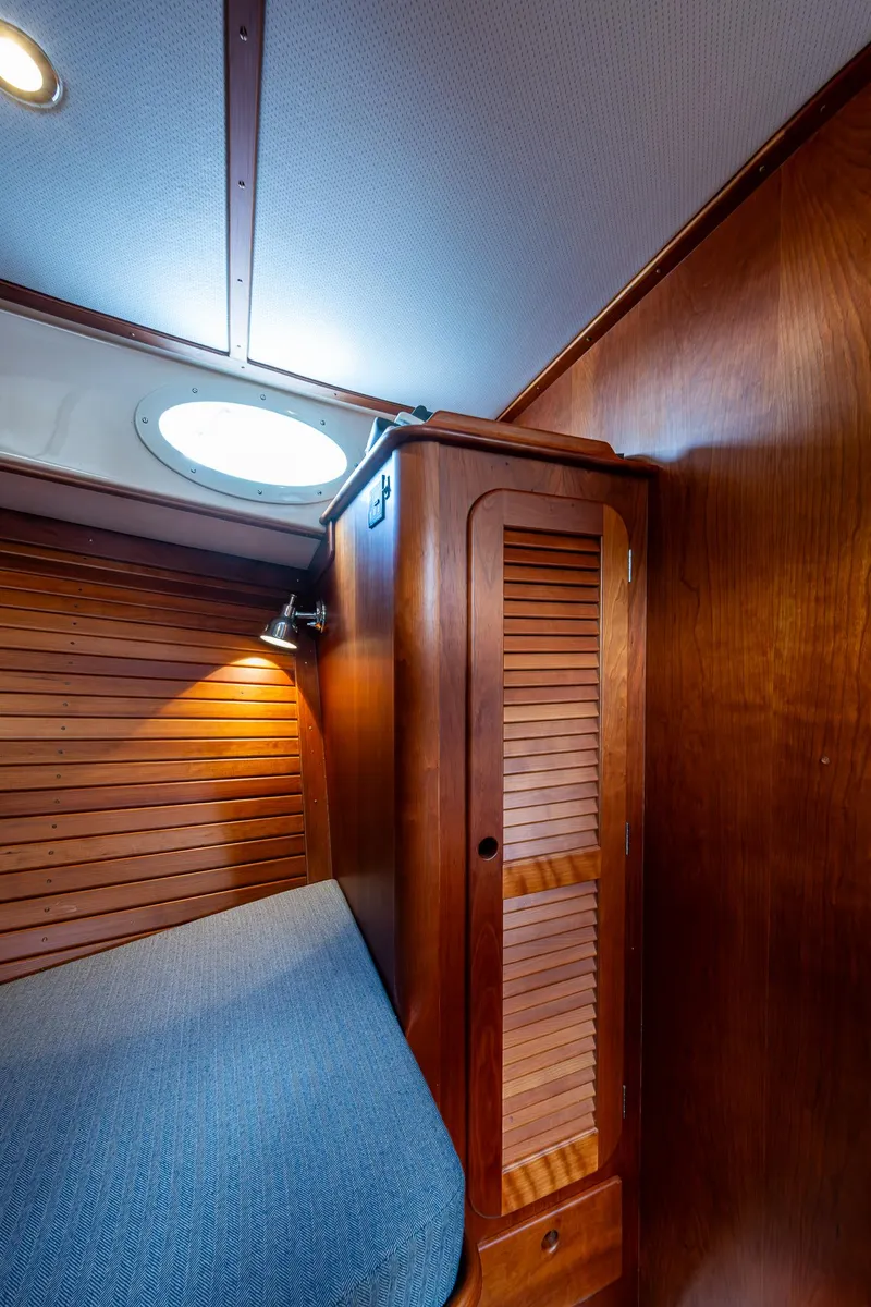 Slide: The Image of Interior cabin of 2017 Hinckley Picnic Boat 37 MKIII with wooden paneling and cozy bed. - 22