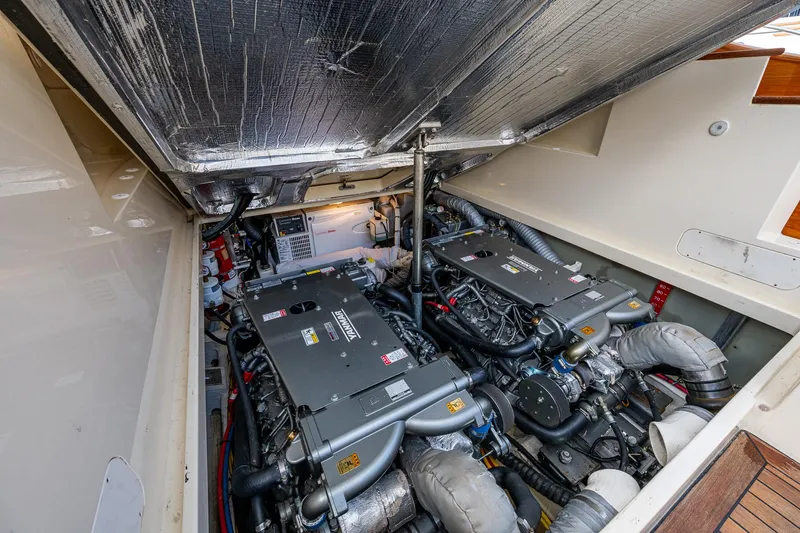 Slide: The Image of Engine compartment of 2017 Hinckley Picnic Boat 37 MKIII, showcasing dual engines and mechanical components. - 28