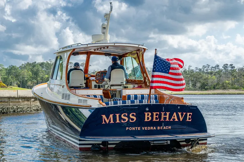 Slide: The Image of 2017 Hinckley Picnic Boat 37 MKIII cruising with American flag, named "Miss Behave." - 4