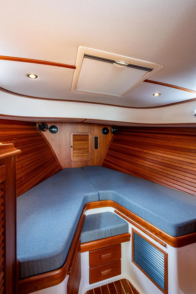 Slide: The Image of 2017 Hinckley Picnic Boat 37 MKIII cabin with wooden interior and cozy bedding. - 20