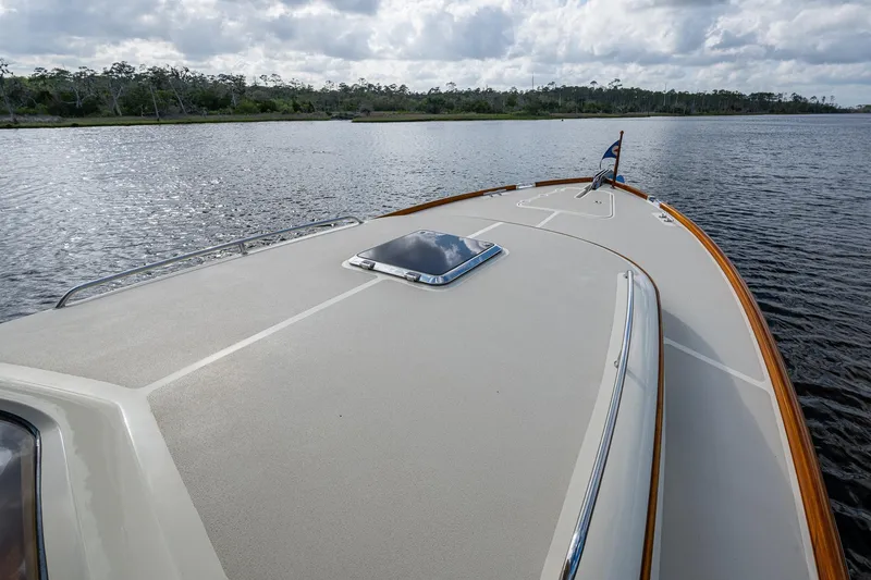 Slide: The Image of 2017 Hinckley Picnic Boat 37 MKIII cruising on a calm river under a cloudy sky. - 29