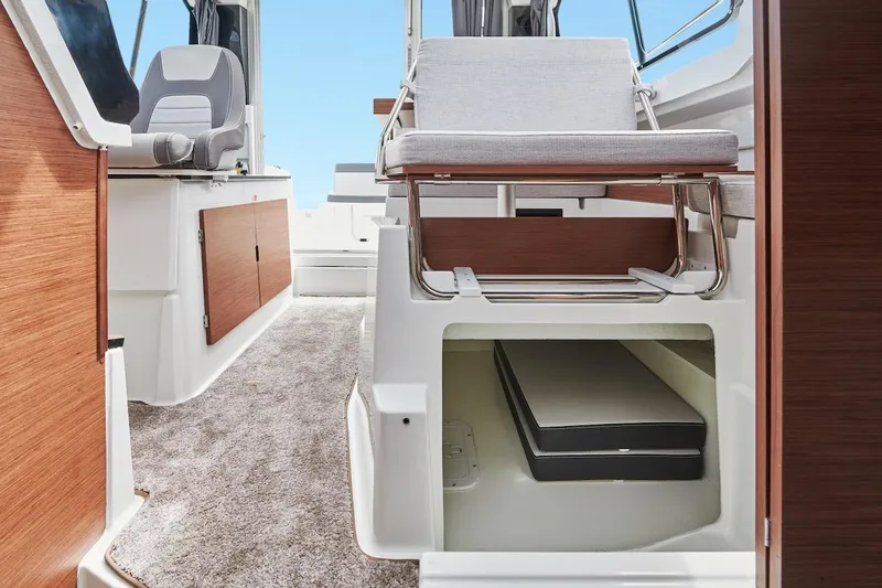 Slide: The Image of Interior of 2025 Jeanneau NC 795 Series 2 boat, featuring seating and storage. - 28