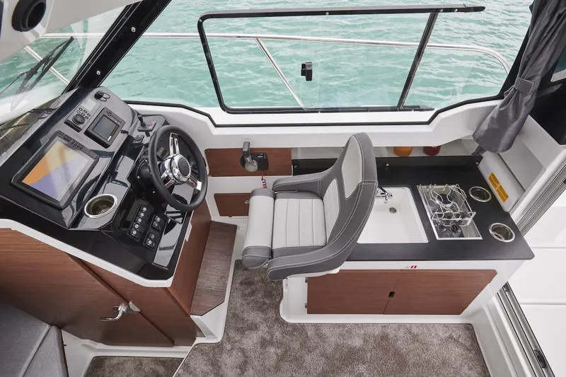 Slide: The Image of Interior of 2025 Jeanneau NC 795 Series 2 boat with helm and kitchenette. - 33