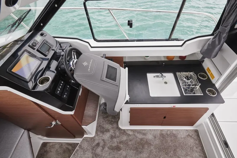 Slide: The Image of Interior of 2025 Jeanneau NC 795 Series 2 boat with helm and kitchenette. - 34
