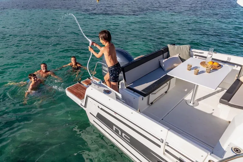 Slide: The Image of Family enjoying water activities near Jeanneau NC 795 Series 2 boat, 2025 model. - 40