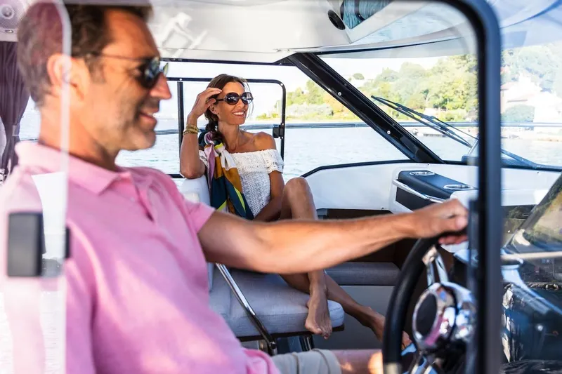 Slide: The Image of Couple enjoying a ride on a 2025 Jeanneau NC 795 Series 2 boat. - 44