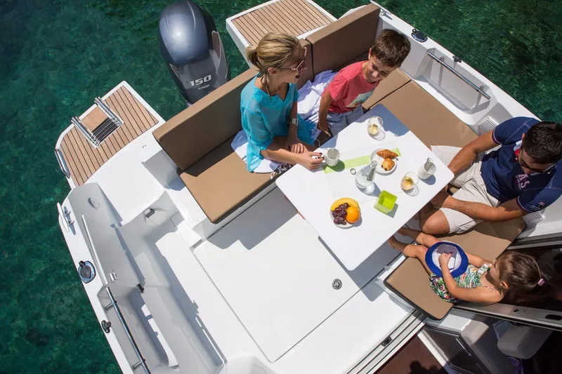 Slide: The Image of 2025 Jeanneau NC 795 Series 2 cruising on open water with passengers enjoying the ride. - 7