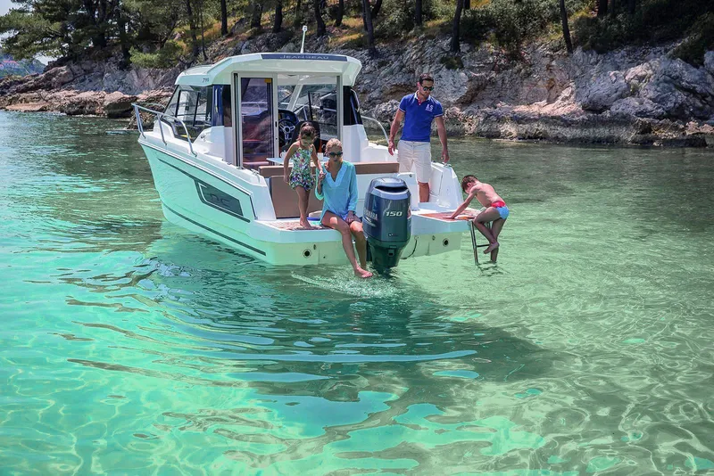 Slide: The Image of 2025 Jeanneau NC 795 boat with family enjoying clear turquoise waters. - 3