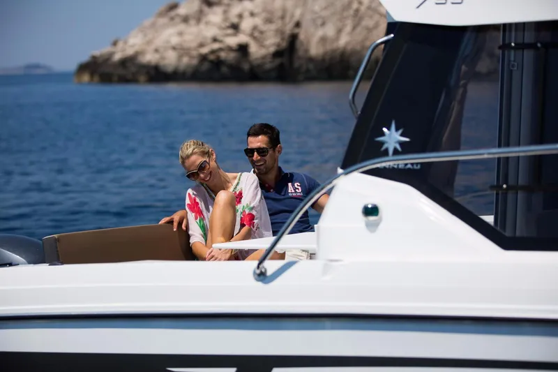Slide: The Image of 2025 Jeanneau NC 795 Series 2 cruising on open water, showcasing sleek design and performance. - 5
