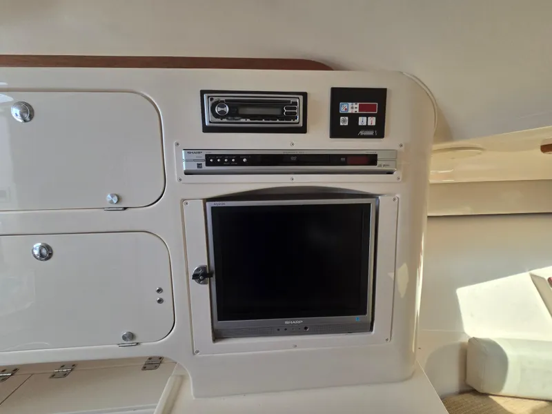 Slide: The Image of 2005 Grady-White 330 Express cabin with built-in electronics and storage compartments. - 10