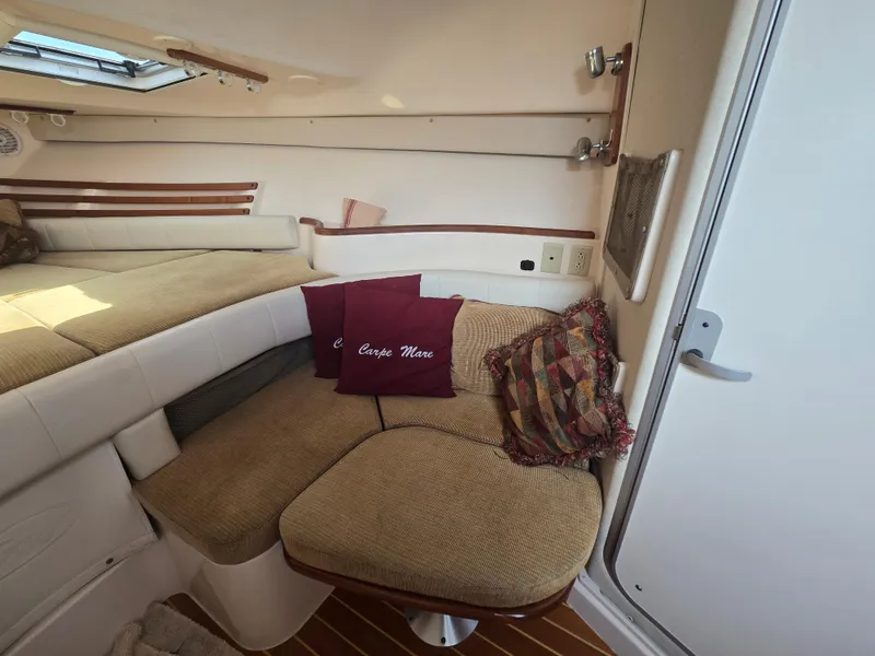 Slide: The Image of 2005 Grady-White 330 Express cabin interior with cozy seating and cushions. - 12