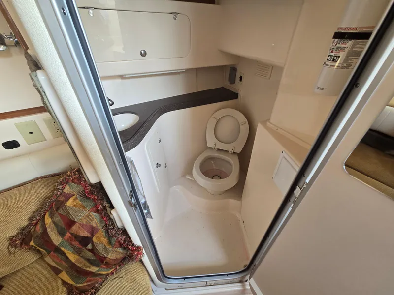 Slide: The Image of 2005 Grady-White 330 Express boat bathroom interior with toilet and sink. - 13