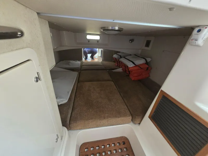 Slide: The Image of 2005 Grady-White 330 Express cabin interior with beds and life jackets. - 14