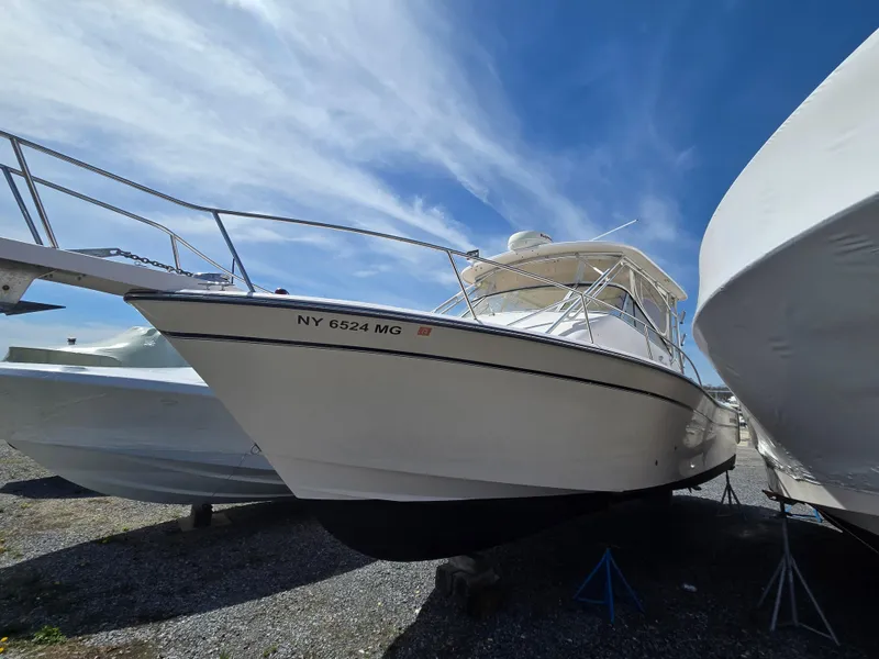Slide: The Image of 2005 Grady-White 330 Express boat on dry dock under a clear blue sky. - 4