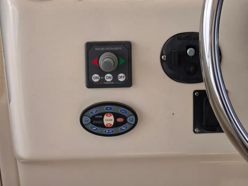 Slide: The Image of Control panel of a 2005 Grady-White 330 Express boat with steering wheel. - 8