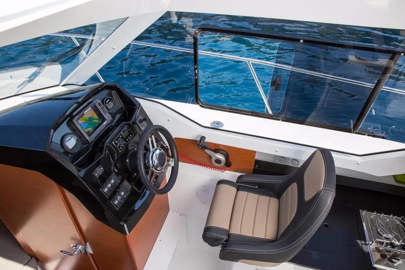 Slide: The Image of Couple enjoying a ride on a 2025 Jeanneau NC 795 Series 2 boat. - 19