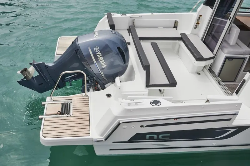 Slide: The Image of 2025 Jeanneau NC 795 Series 2 boat with Yamaha outboard motor on turquoise water. - 29