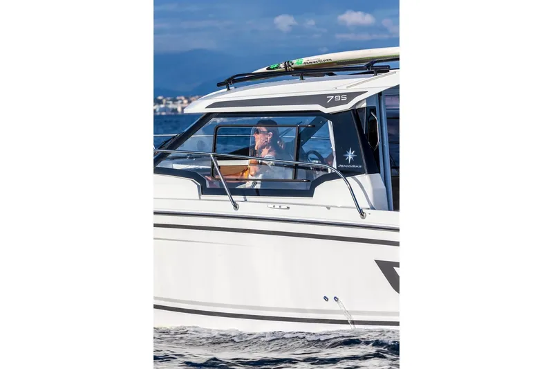 Slide: The Image of 2025 Jeanneau NC 795 Series 2 boat cruising on water, side view. - 45