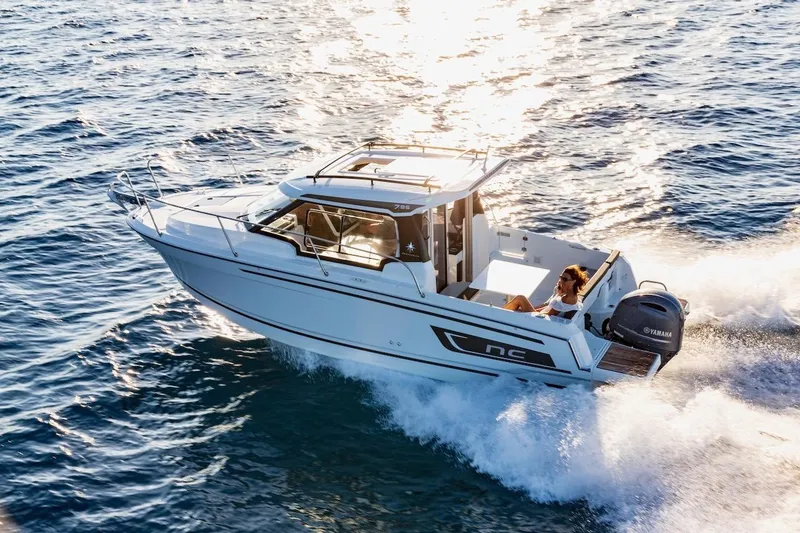 Slide: The Image of 2025 Jeanneau NC 795 Series 2 cruising on open water at sunset. - 9