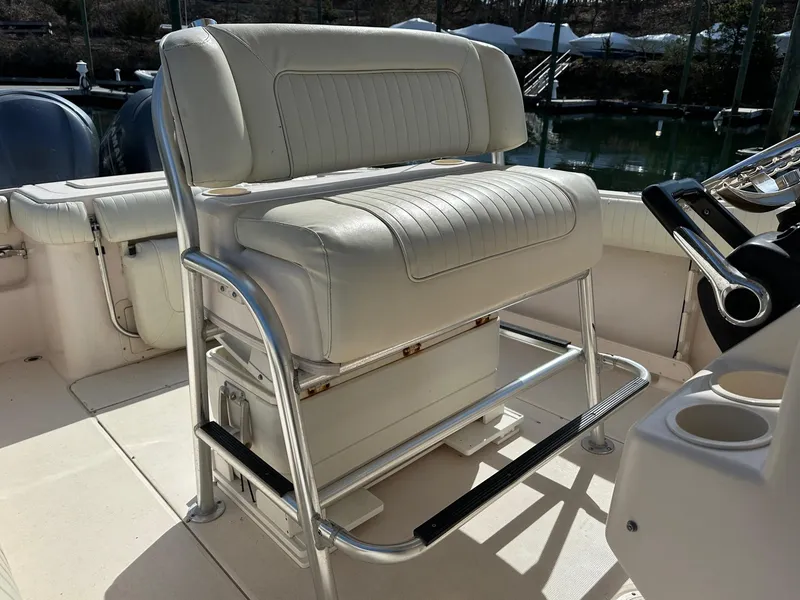Slide: The Image of 2007 Grady-White 273 CHASE boat seat with white upholstery and metal frame. - 11
