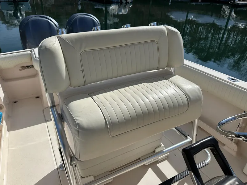 Slide: The Image of 2007 Grady-White 273 CHASE boat seat with white upholstery and stainless steel frame. - 12