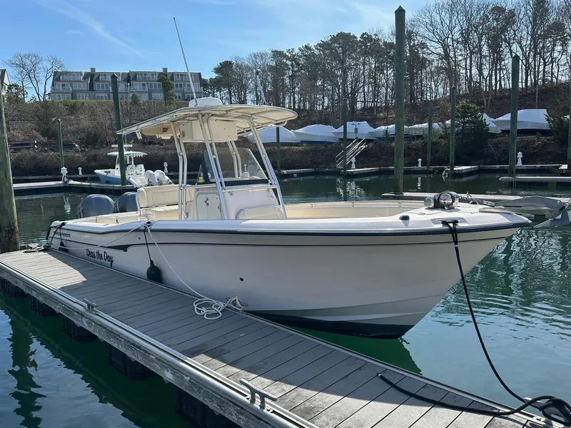 Slide: The Image of 2007 Grady-White 273 CHASE boat docked in a marina, clear sky background. - 2