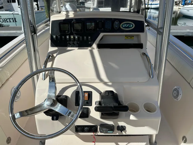 Slide: The Image of 2007 Grady-White 273 CHASE boat console with steering wheel and controls. - 6