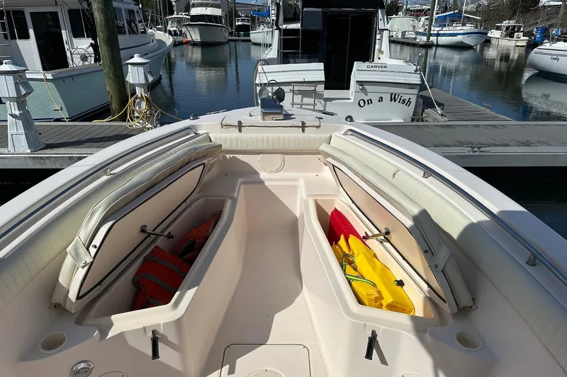 Slide: The Image of 2007 Grady-White 273 CHASE boat with open storage compartments at a marina. - 9
