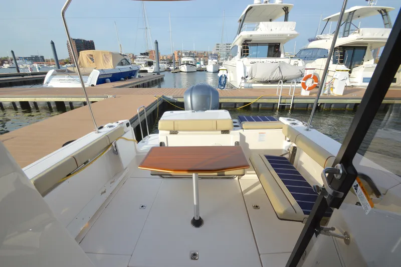 Slide: The Image of 2020 Ranger Tugs R-27 boat interior at marina, featuring seating and table. - 10