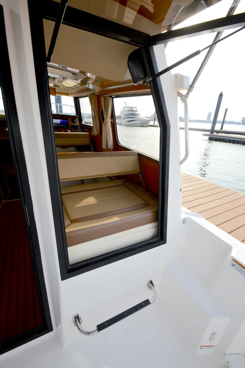 Slide: The Image of 2020 Ranger Tugs R-27 interior view with dock and water in background. - 11