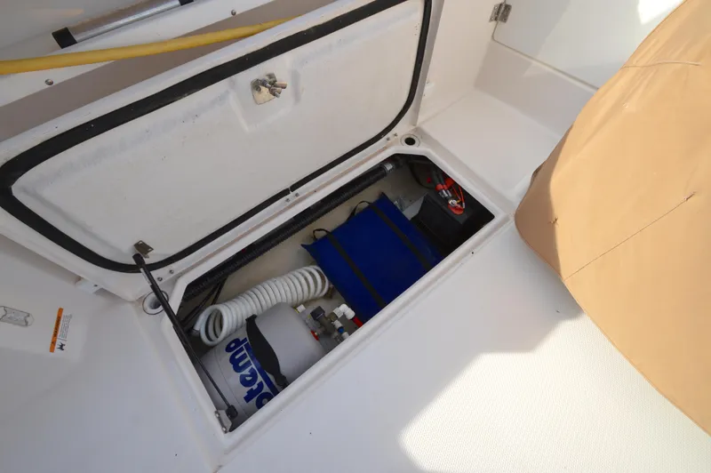 Slide: The Image of Storage compartment of 2020 Ranger Tugs R-27 boat with equipment and supplies. - 13