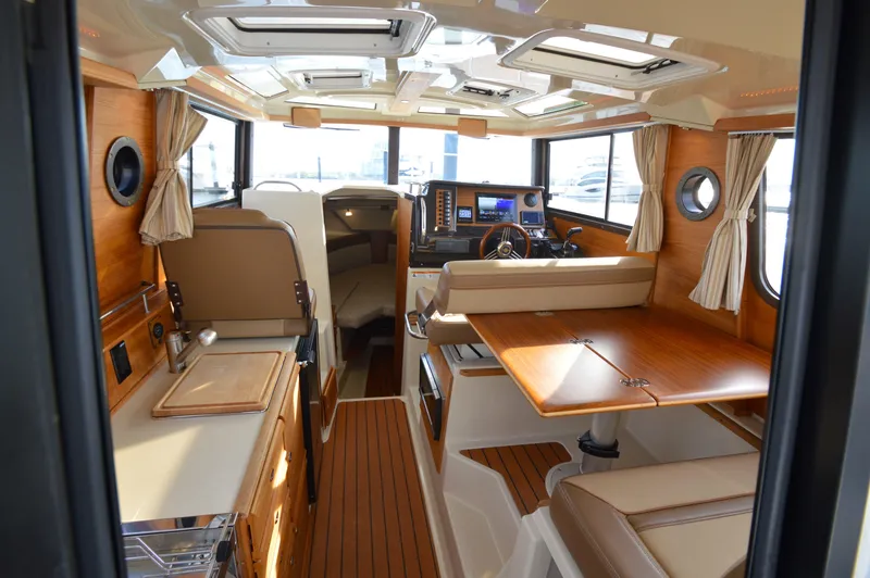 Slide: The Image of Interior of 2020 Ranger Tugs R-27 boat with wood accents and modern amenities. - 15